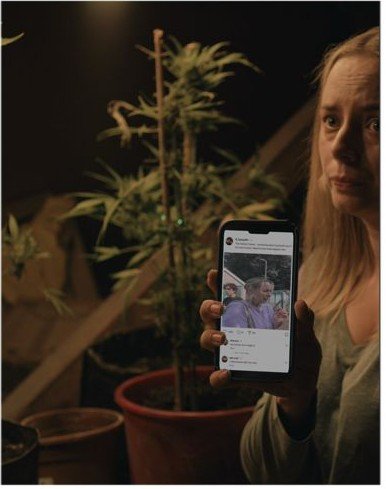 Maddy watching footage of her panic attack on her phone, the image aligning with the film's own frame